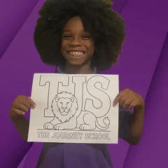 girl holding the journey school sign