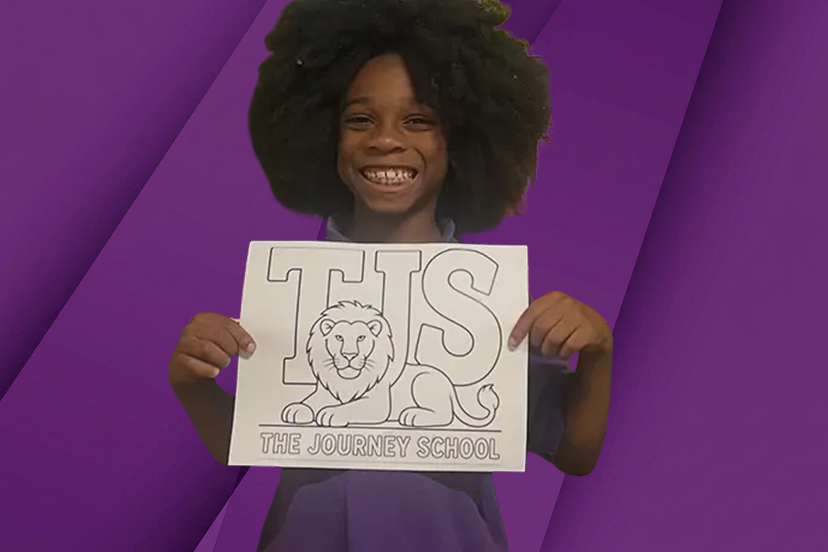 girl holding the journey school sign