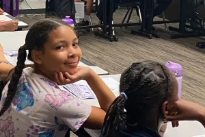 girl in class with mona lisa smile